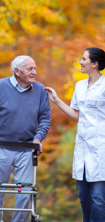 Nurse Assisting Elderly Man with a walker